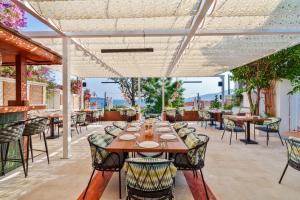 an outdoor dining area with tables and chairs and a table and chairsktop at Kalkan Port Hotel in Kaş