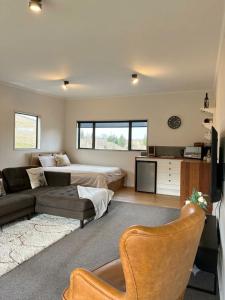 a living room with a bed and a couch at Clydesvale Apartment in Clyde +13 photos