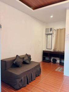 a living room with a couch and a microwave at Alicia's Guest House in Butuan