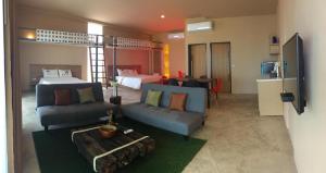 a living room with a couch and a bed at Red Z The Ocean in Ban Tanot Noi