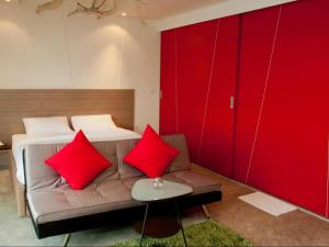a room with a couch with two red pillows at Red Z The Ocean in Ban Tanot Noi +50 photos