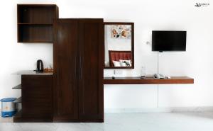 a wooden cabinet with a television in a room at Velowyn Ella in Ella