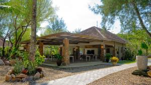 a house with a pavilion in a garden at Amandalay Hotel & Villas in Karimunjawa +11 photos