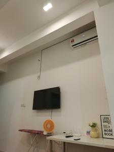 a flat screen tv hanging on a wall at Amin Studio Apartment Pool And Netflix in Gua Musang
