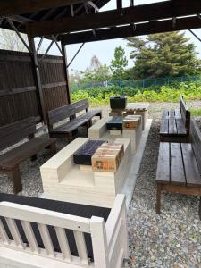 a group of park benches sitting under a pavilion at Lei Toya in Sobetsu