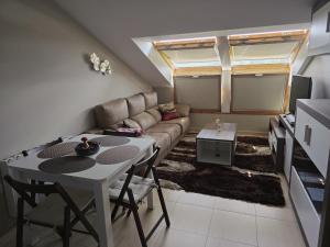 a living room with a couch and a table at Mirador do Xistral in Valle de Oro