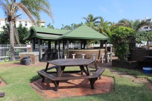 a picnic table and a gazebo in a yard at Dumela Margate Flat No 11 in Margate