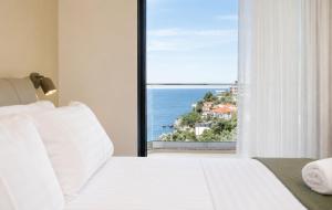 a bedroom with a bed with a view of the ocean at Rajna Apartments in Ulcinj +79 photos