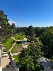 an overhead view of a park with trees and a road at Shkreli Resort Qafeshtame in Krujë