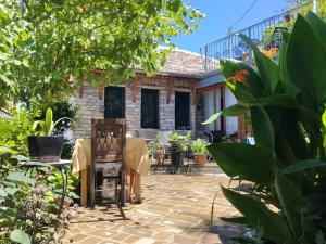 a patio with a table and chairs in front of a house at "Villa 70" Guesthouse in Gjirokastër