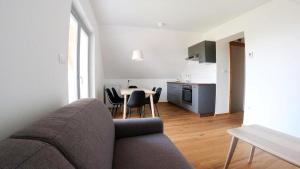 a living room with a couch and a table with chairs at Barn House in Ptuj