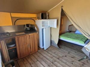 a room with a tent with a bed in it at Camping les 2 salamandres in Arces-sur-Gironde