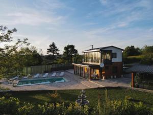 a house with a pool and a lot of windows at Vidikovac Cazin in Cazin +9 photos