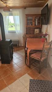 a dining room with a table and a stove at Zinnia Vendégház in Nagyrada