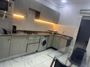 a kitchen with a washing machine in a kitchen at Tarek in Oran
