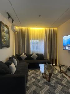 a living room with a couch and a glass table at Tarek in Oran +5 photos