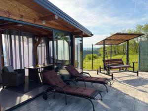 a patio with chairs and a table with a view at Vidikovac Cazin in Cazin