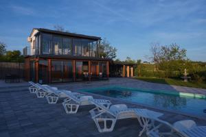 a house with a swimming pool and some chairs at Vidikovac Cazin in Cazin