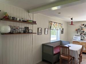 a dining room with a table and a table and a kitchen at Dockstavägen 7 in Docksta