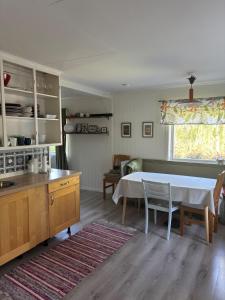 a kitchen with a table in the middle of a room at Dockstavägen 7 in Docksta +17 photos