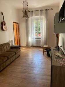 a living room with a couch and a window at Il Sogno di Giorgio in Chiavari