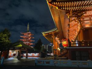 a building with two towers in a city at night at ホテル スミヨシホルモン in Tokyo