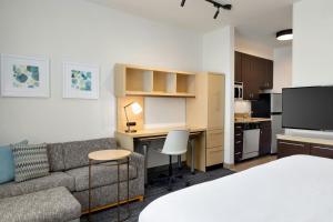 a living room with a couch and a desk in a room at TownePlace Suites by Marriott Phoenix Goodyear in Goodyear