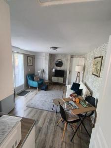 a living room with a table and a couch at The apartment in Saint-Rabier