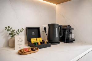 a coffeemaker sitting on a counter with a coffee maker at JIJI Suites Sénart in Combs-la-Ville