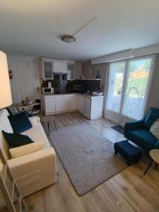 a living room with a couch and a kitchen at The apartment in Saint-Rabier