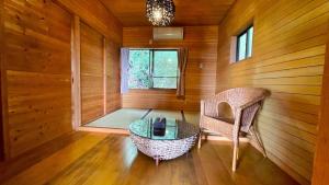 a room with a chair and a table and a window at Balistyle Tateyama View in Tateyama