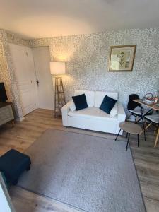 a living room with a white couch and a table at The apartment in Saint-Rabier +22 photos