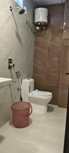a bathroom with a toilet and a sink at Magnet Hotel in Vijayawāda +34 photos