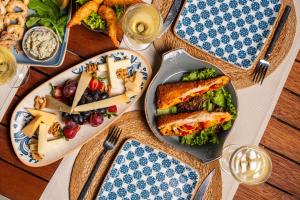 a wooden table with plates of food on it at Les Terrasses De Selimiye in Selimiye