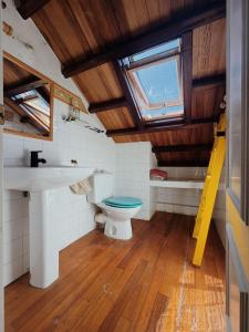 a bathroom with a toilet and a sink and a window at Casa Malde in Cedeira +67 photos