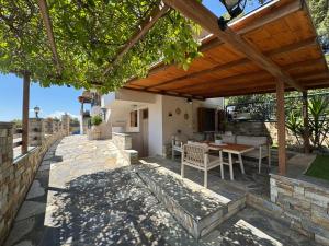 an outdoor patio with a wooden pergola at Aegean View Mikro Pelion in Mikro