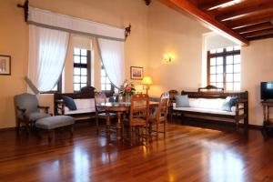 a living room with a table and chairs at Nissia Traditional Residences Spetses in Spetses