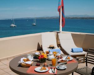 a table with food on it with a view of the ocean at Nissia Traditional Residences Spetses in Spetses
