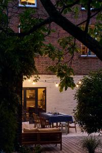 a blue table and chairs in front of a building at Historic Brewery Cottage in Dorset Village Sleeps 10 in Fontmell Magna