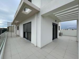 an empty balcony of a white building with a view at Athenean Gem Near Metro Mall in Athens