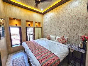 a bedroom with a large bed in a room at Zipcode Kashi in Varanasi