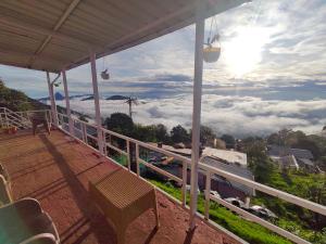 a balcony with a view of the clouds at Emerald home stay in Kodaikānāl