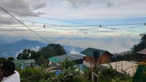 a person is looking at a view of a mountain at Emerald home stay in Kodaikānāl