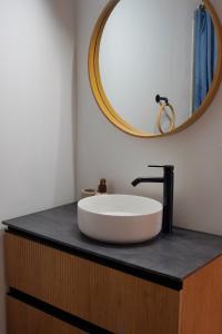 a bathroom with a white sink and a mirror at Toca da raposa in Raposeira +26 photos