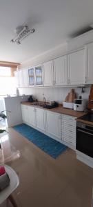 a kitchen with white cabinets and a counter top at Azurara Beach Nest in Azurara +5 photos