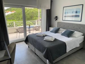 a bedroom with a bed and a balcony at Apartments No26 in Povile