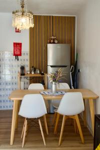 a kitchen with a table and chairs and a refrigerator at Toca da raposa in Raposeira