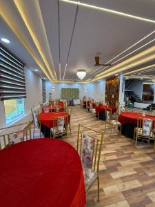 a dining room with red tables and chairs at Oliv Faram house in Greater Noida