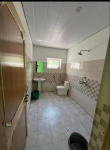 a bathroom with a toilet and a sink at Tsetanpa homestay in Leh