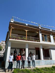 a group of people standing in front of a building at Tsetanpa homestay in Leh